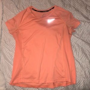 Bright orange Nike athletic top! Size L but can also fit a S or M.